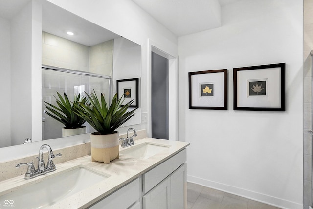 15387 Alperton Rd, Fishers, IN 46037 - bathroom featuring double vanity, tile patterned flooring, tiled shower, and baseboards