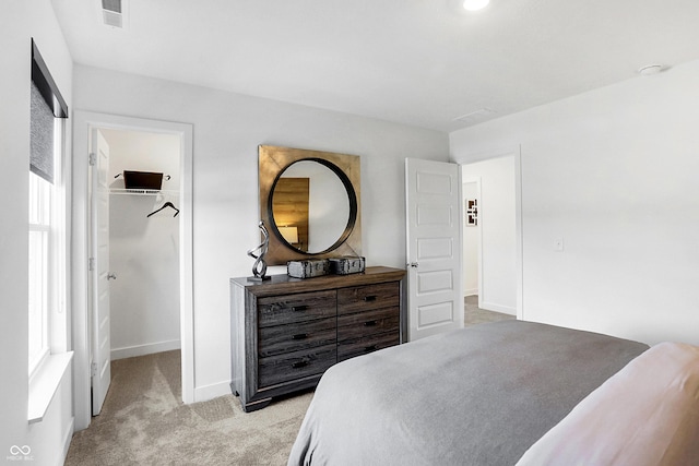 15387 Alperton Rd, Fishers, IN 46037 - bedroom featuring a walk in closet, light colored carpet, baseboards, and a closet