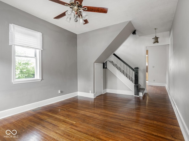 914 English Ave, Indianapolis, IN 46203 - unfurnished room with hardwood / wood-style floors, stairs, a ceiling fan, and baseboards