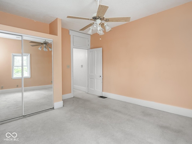 914 English Ave, Indianapolis, IN 46203 - unfurnished bedroom featuring light colored carpet, baseboards, a closet, and a ceiling fan