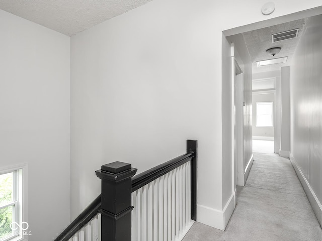 914 English Ave, Indianapolis, IN 46203 - hall featuring an upstairs landing, light carpet, a textured ceiling, and baseboards