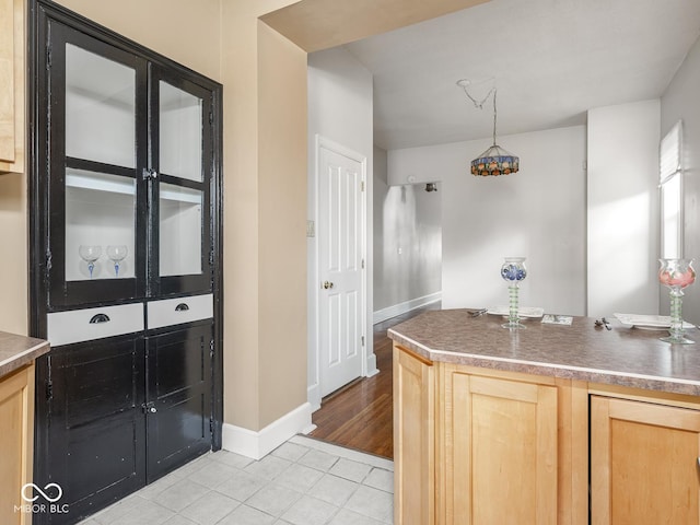 914 English Ave, Indianapolis, IN 46203 - kitchen featuring light brown cabinets, light tile patterned floors, baseboards, a chandelier, and pendant lighting