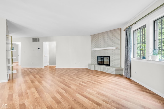 2267 Rome Dr Unit A, Indianapolis, IN 46228 - unfurnished living room with light wood-style flooring and a fireplace