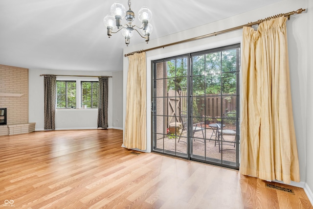 2267 Rome Dr Unit A, Indianapolis, IN 46228 - unfurnished dining area featuring a chandelier, wood finished floors, and a fireplace