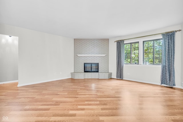 2267 Rome Dr Unit A, Indianapolis, IN 46228 - unfurnished living room featuring wood finished floors and a brick fireplace