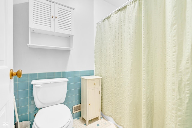 2267 Rome Dr Unit A, Indianapolis, IN 46228 - full bathroom featuring wainscoting, tile walls, and a shower with shower curtain