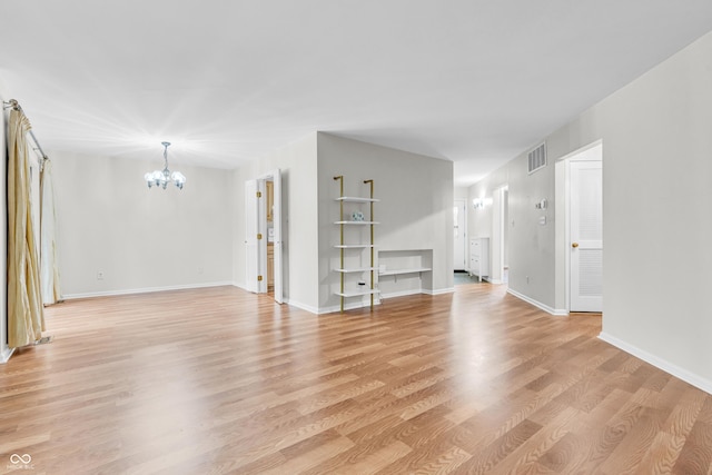 2267 Rome Dr Unit A, Indianapolis, IN 46228 - unfurnished living room with a chandelier and light wood-style floors