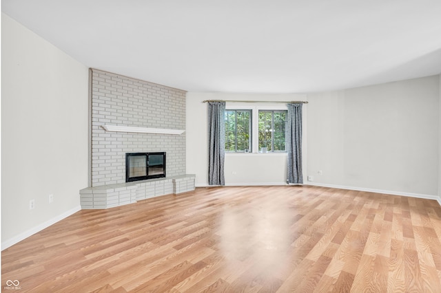 2267 Rome Dr Unit A, Indianapolis, IN 46228 - unfurnished living room featuring wood finished floors and a fireplace