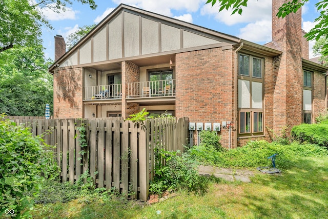2267 Rome Dr Unit A, Indianapolis, IN 46228 - view of front facade with a chimney, brick siding, and a balcony