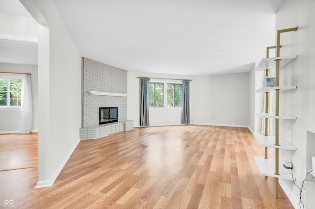 2267 Rome Dr Unit A, Indianapolis, IN 46228 - unfurnished living room featuring healthy amount of natural light, wood finished floors, and a fireplace