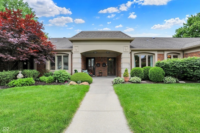 423 Bent Tree Ln, Indianapolis, IN 46260 - view of front of property with brick siding, a front yard, and roof with shingles