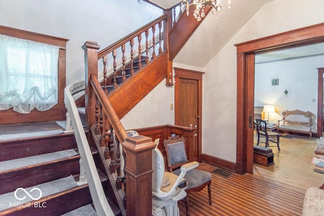 4526 Iowa St, Clayton, IN 46118 - staircase featuring lofted ceiling and a chandelier