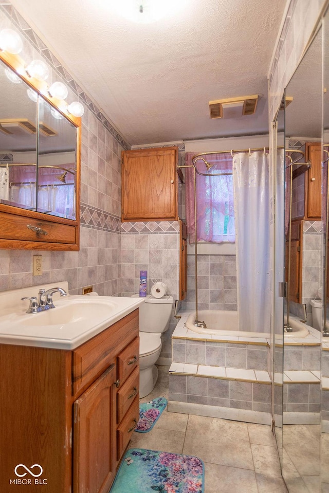 4526 Iowa St, Clayton, IN 46118 - full bathroom with toilet, vanity, tile walls, tiled shower / bath combo, and tile patterned floors