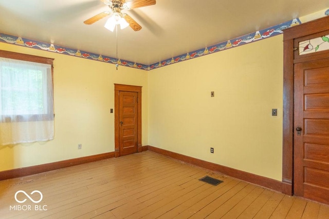 4526 Iowa St, Clayton, IN 46118 - empty room with light wood-style flooring, ceiling fan, and baseboards