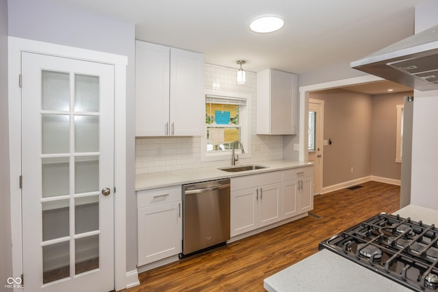 4933 W 13th St W, Speedway, IN 46224 - kitchen featuring stainless steel dishwasher, a sink, dark wood finished floors, tasteful backsplash, and stovetop
