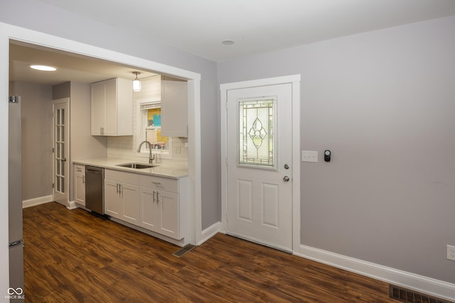 4933 W 13th St W, Speedway, IN 46224 - kitchen featuring a sink, stainless steel dishwasher, baseboards, dark wood-style flooring, and light countertops