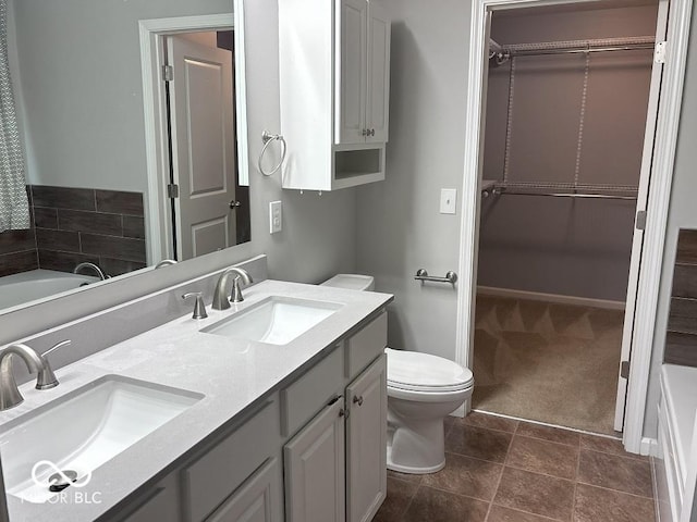 1287 Highland Lake Way, Brownsburg, IN 46112 - bathroom with double vanity, a walk in closet, toilet, and a bath
