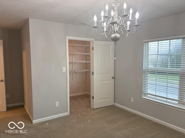 1287 Highland Lake Way, Brownsburg, IN 46112 - unfurnished dining area featuring carpet floors, baseboards, and a chandelier