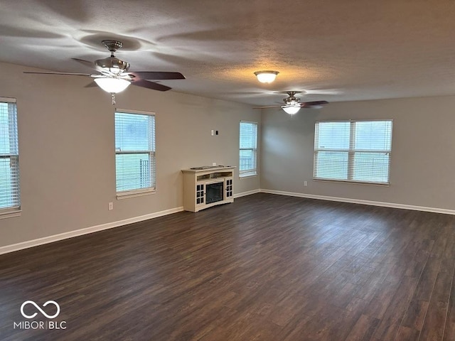 1287 Highland Lake Way, Brownsburg, IN 46112 - unfurnished living room featuring a ceiling fan, dark wood finished floors, a textured ceiling, and baseboards