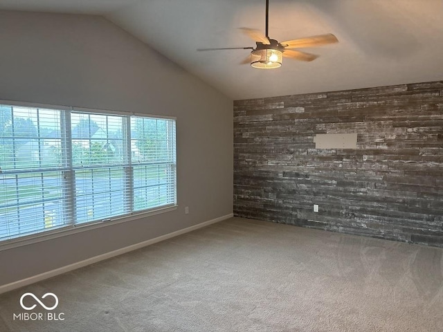 1287 Highland Lake Way, Brownsburg, IN 46112 - spare room featuring ceiling fan, wooden walls, carpet flooring, lofted ceiling, and baseboards
