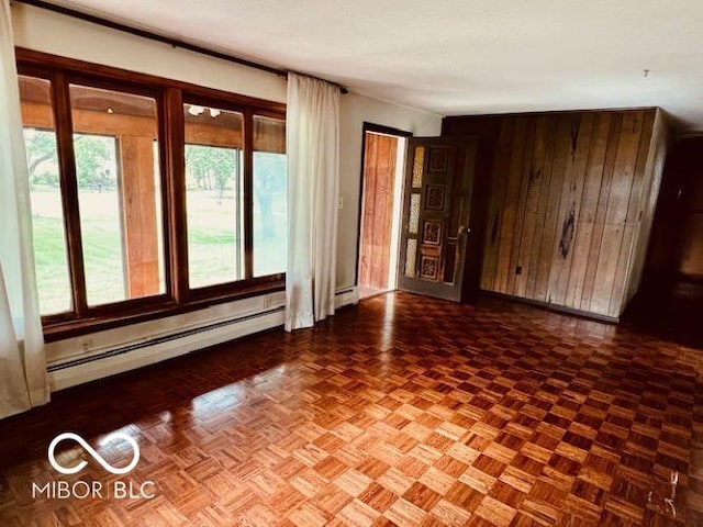 3824 Forest Ridge Dr, Fort Wayne, IN 46804 - spare room with a baseboard heating unit, wooden walls, and a baseboard radiator