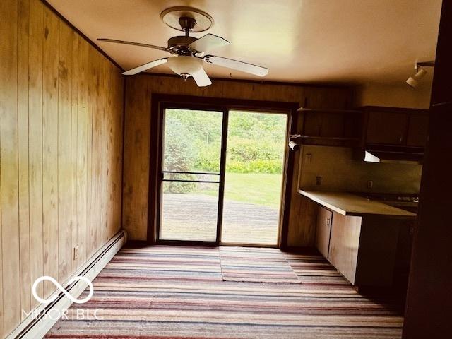 3824 Forest Ridge Dr, Fort Wayne, IN 46804 - kitchen featuring wood walls, baseboard heating, a ceiling fan, and light countertops