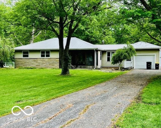 3824 Forest Ridge Dr, Fort Wayne, IN 46804 - single story home featuring driveway, an attached garage, stone siding, and a front lawn