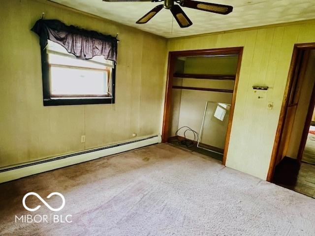 3824 Forest Ridge Dr, Fort Wayne, IN 46804 - unfurnished bedroom featuring carpet flooring, a baseboard radiator, a closet, and a ceiling fan