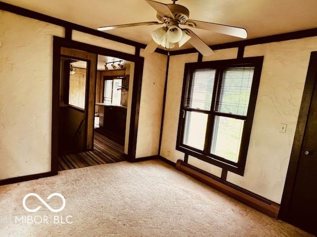 3824 Forest Ridge Dr, Fort Wayne, IN 46804 - carpeted spare room featuring baseboards, a ceiling fan, and a baseboard heating unit