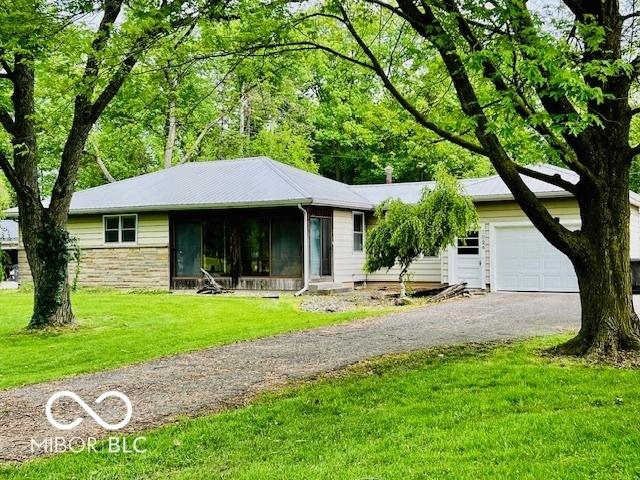 3824 Forest Ridge Dr, Fort Wayne, IN 46804 - ranch-style house with a garage, asphalt driveway, a front lawn, and stone siding
