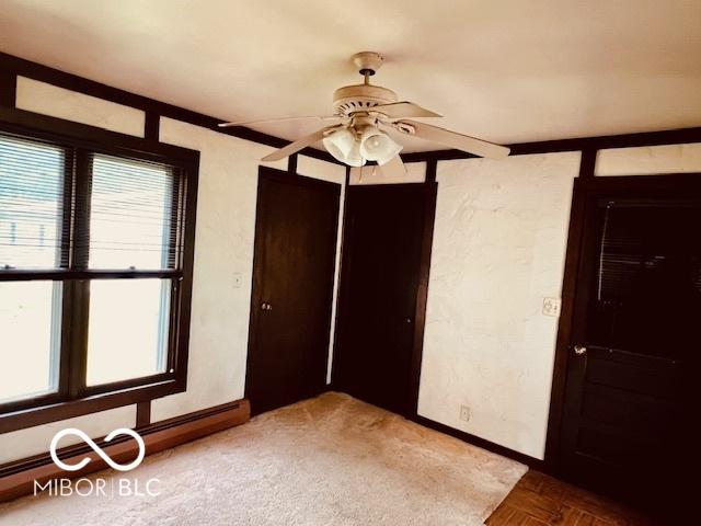 3824 Forest Ridge Dr, Fort Wayne, IN 46804 - unfurnished bedroom with baseboards, a baseboard heating unit, a closet, and ceiling fan