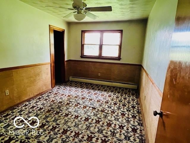 3824 Forest Ridge Dr, Fort Wayne, IN 46804 - spare room with a baseboard radiator, wainscoting, and ceiling fan