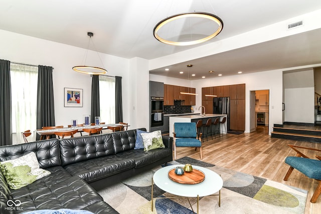 1620 W New York St, Indianapolis, IN 46222 - living area featuring light wood-type flooring, plenty of natural light, and recessed lighting