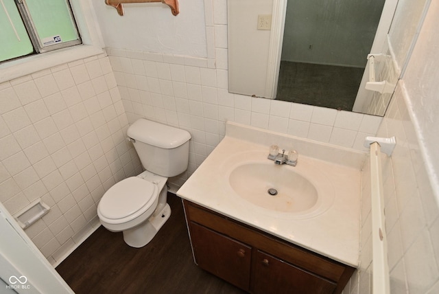 2622 Ethel Ave, Indianapolis, IN 46208 - bathroom with tile walls, toilet, vanity, and wood finished floors