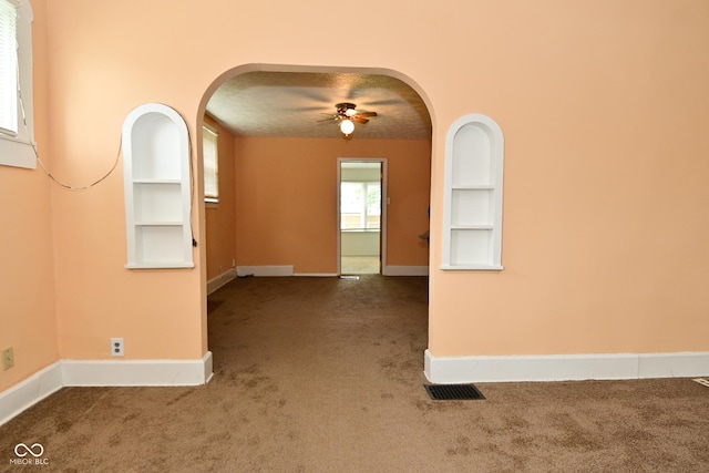 2622 Ethel Ave, Indianapolis, IN 46208 - carpeted spare room with arched walkways, a ceiling fan, baseboards, and built in shelves