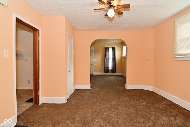 2622 Ethel Ave, Indianapolis, IN 46208 - unfurnished room featuring arched walkways, carpet, a ceiling fan, a textured ceiling, and healthy amount of natural light