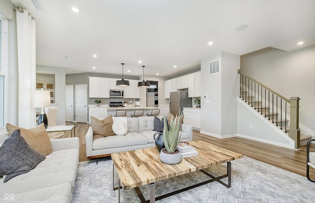 600 Dalton Way, Avon, IN 46123 - living area featuring light wood-style floors, stairs, recessed lighting, and baseboards
