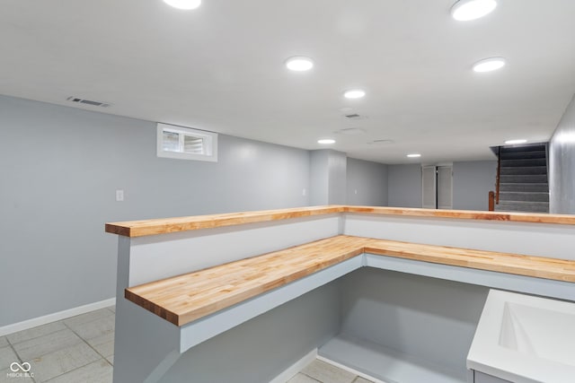3735 Marrison Pl, Indianapolis, IN 46205 - bar featuring baseboards, recessed lighting, and stairway