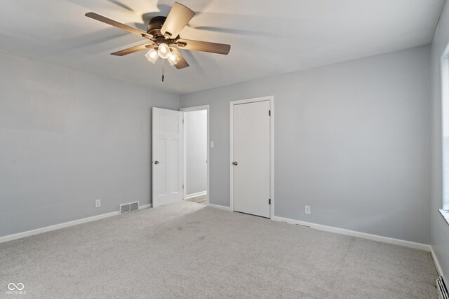 3735 Marrison Pl, Indianapolis, IN 46205 - unfurnished bedroom featuring carpet floors, baseboards, baseboard heating, and a ceiling fan