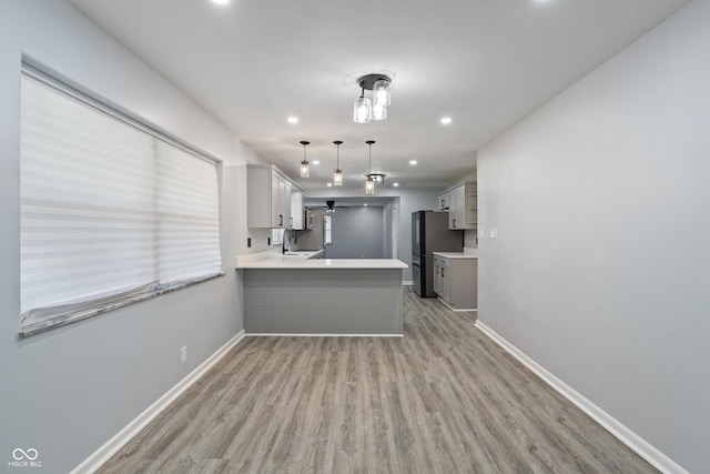 3735 Marrison Pl, Indianapolis, IN 46205 - kitchen featuring a peninsula, gray cabinetry, light wood-type flooring, baseboards, and recessed lighting