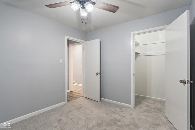 3735 Marrison Pl, Indianapolis, IN 46205 - unfurnished bedroom featuring carpet floors, baseboards, a closet, ceiling fan, and a walk in closet