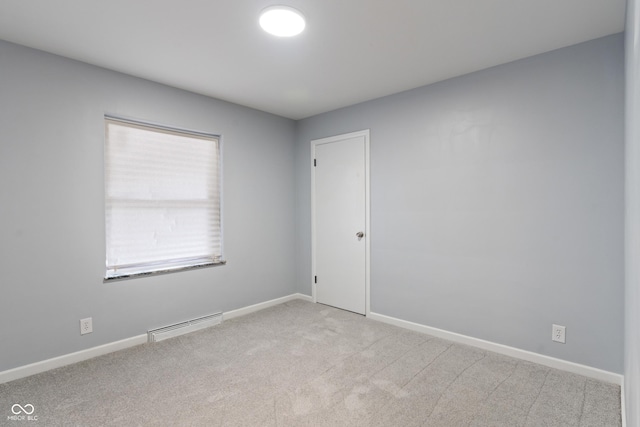 3735 Marrison Pl, Indianapolis, IN 46205 - spare room featuring light colored carpet, a baseboard heating unit, and baseboards
