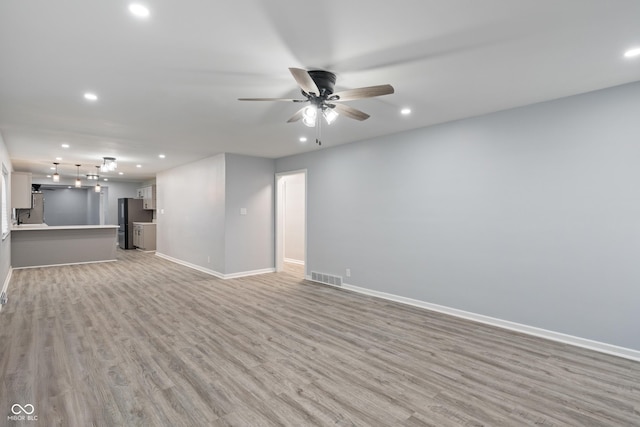 3735 Marrison Pl, Indianapolis, IN 46205 - unfurnished living room featuring recessed lighting, baseboards, light wood-style floors, and a ceiling fan