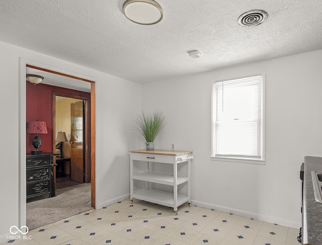 4305 Clinton St, Lawrence, IN 46226 - dining area featuring a textured ceiling and baseboards