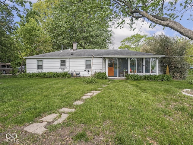 4305 Clinton St, Lawrence, IN 46226 - rear view of property with a lawn, a sunroom, and a chimney