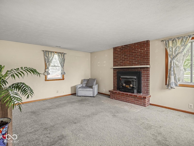 4305 Clinton St, Lawrence, IN 46226 - unfurnished living room with carpet floors, plenty of natural light, a textured ceiling, baseboards, and a brick fireplace