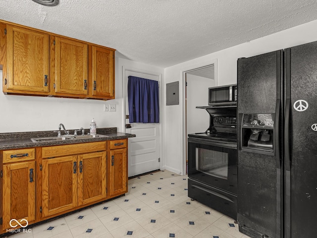 4305 Clinton St, Lawrence, IN 46226 - kitchen with black appliances, a sink, brown cabinetry, electric panel, and a textured ceiling