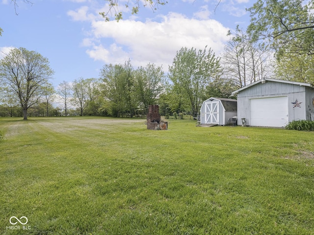 4305 Clinton St, Lawrence, IN 46226 - view of green lawn featuring a detached garage