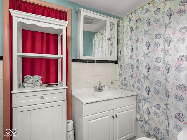 4305 Clinton St, Lawrence, IN 46226 - full bathroom with decorative backsplash, vanity, and a shower with curtain