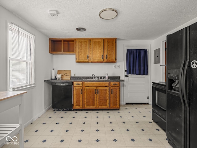 4305 Clinton St, Lawrence, IN 46226 - kitchen with black appliances, a sink, brown cabinets, a textured ceiling, and electric panel